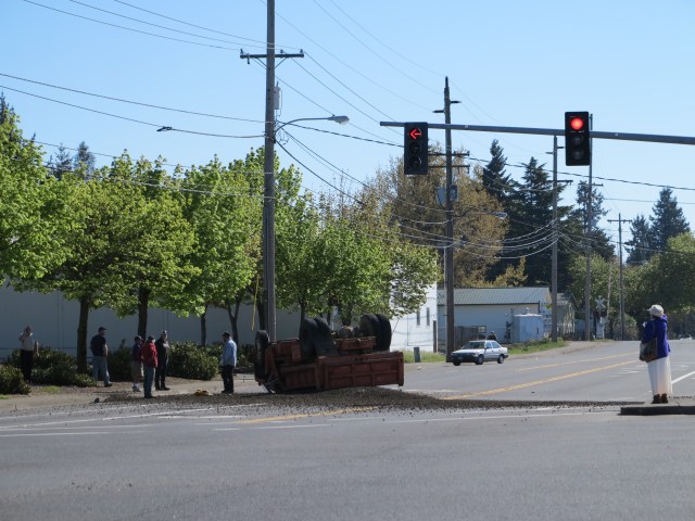 The lady in the white dress, lucky she did not walk faster or the truck would have hit her