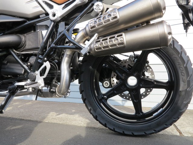Footpegs are positioned slightly lower than on the roadster. The Akrapovic exhaust is "scramblerized"